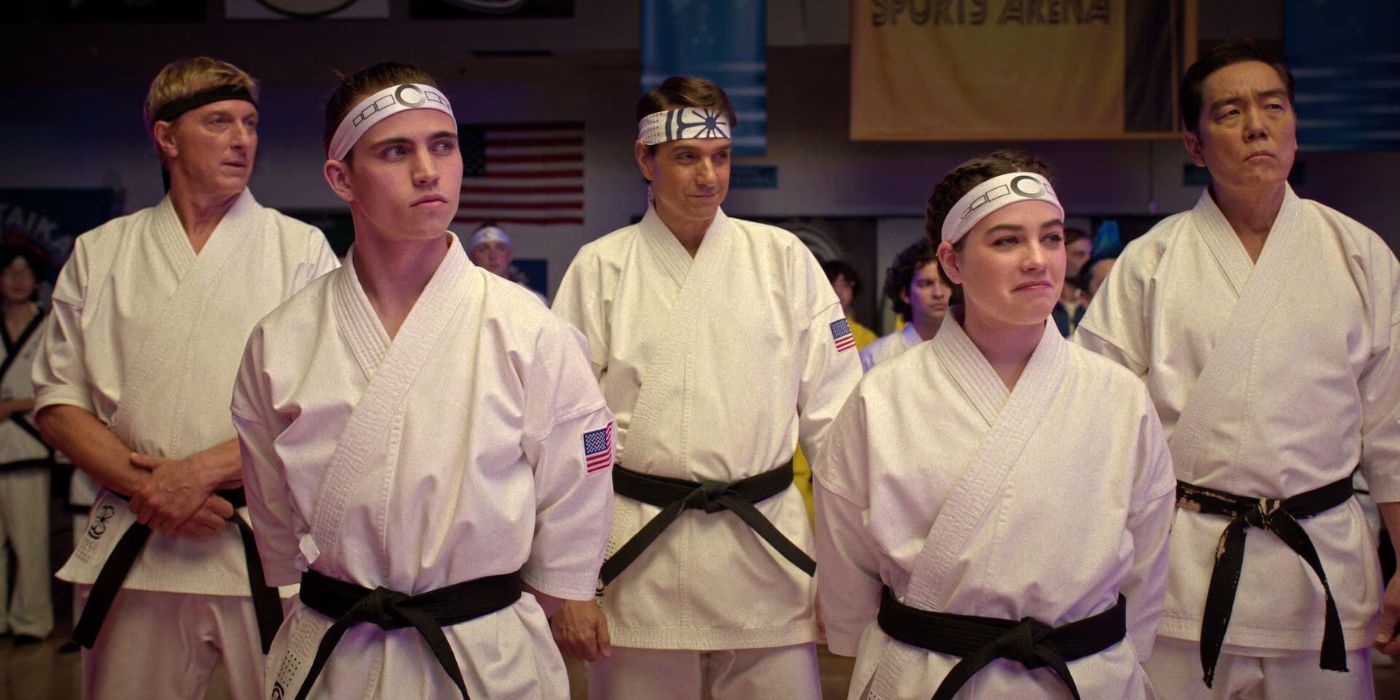 Johnny, Robbie, Daniel, Sam and Chozen standing in the tournament center in Cobra Kai Season 6, Episode 13.