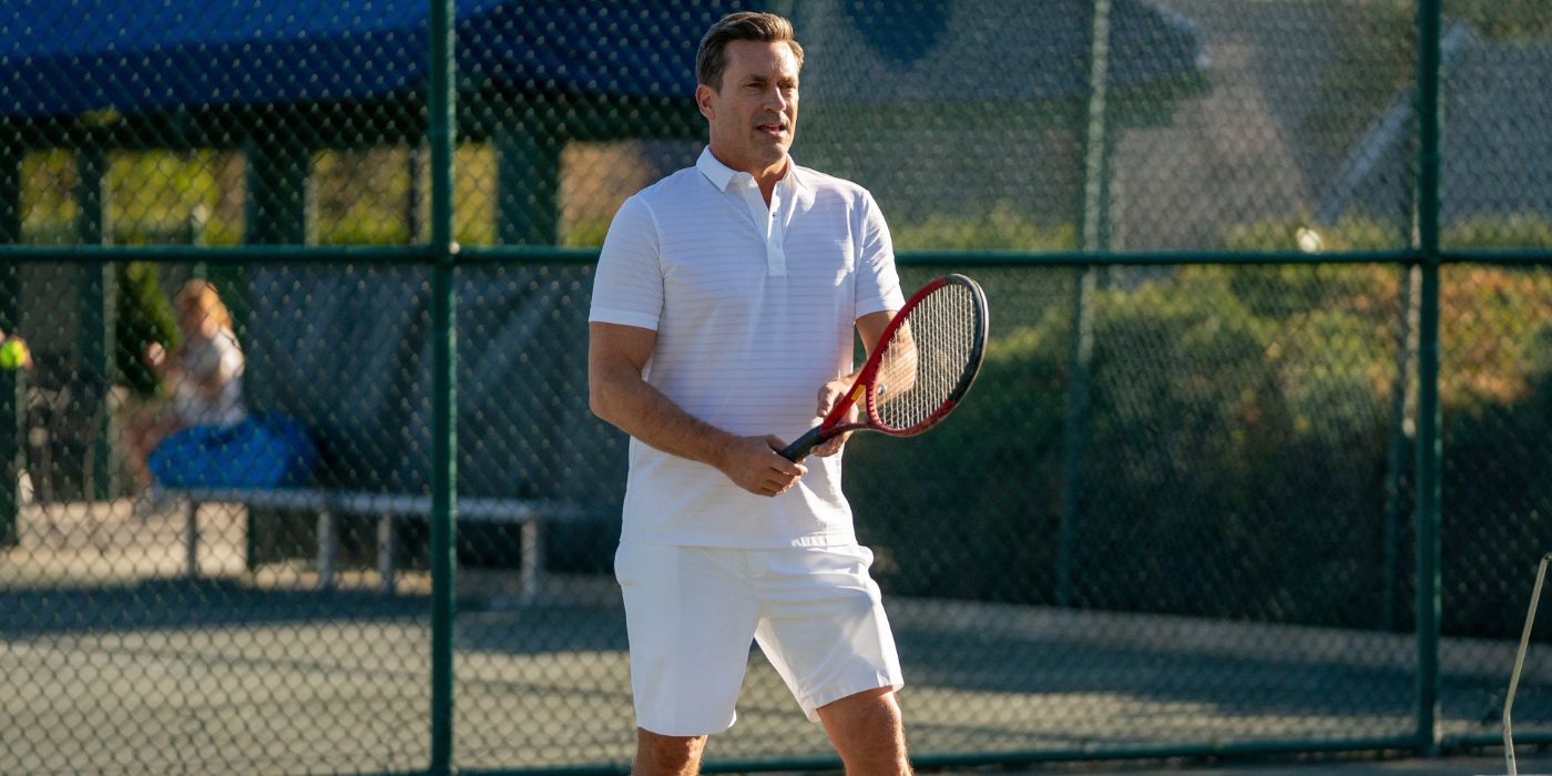 Jon Hamm as Coop, at a tennis court holding a racket in Your Friends and Neighbors.