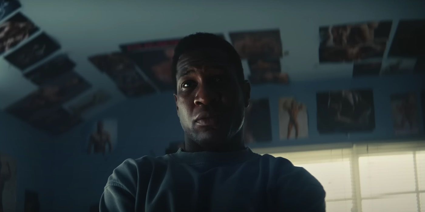Jonathan Majors, frowning in a room, in Magazine Dreams