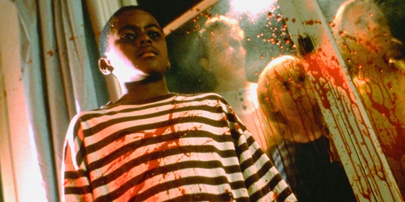 Marcus, played by Lewis Flanagan III, looks down while covered in blood in Children of the Corn IV: The Gathering.