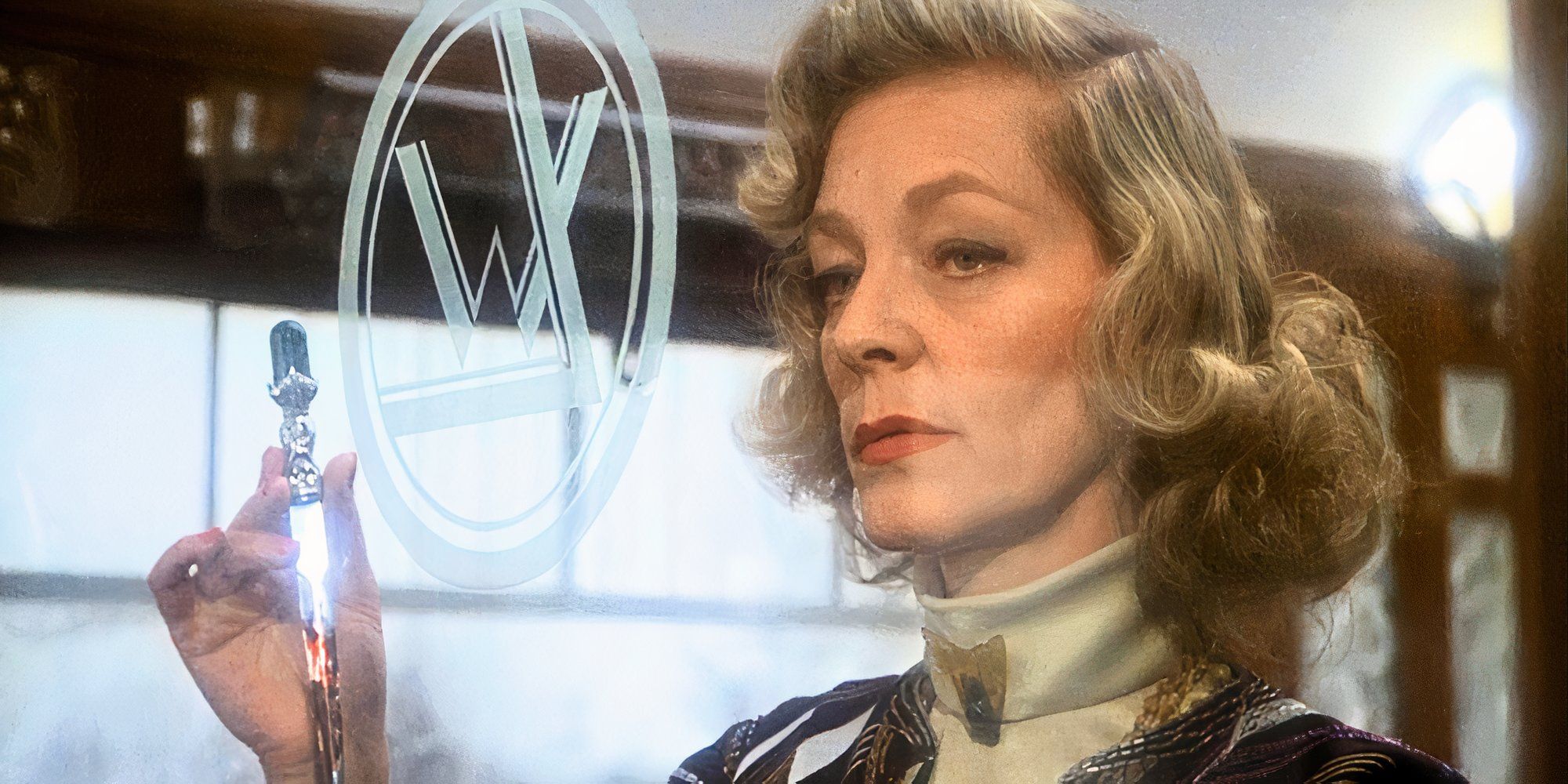 Lauren Bacall holding up a pocketknife with blood on the blade in Murder on the Orient Express (1974).