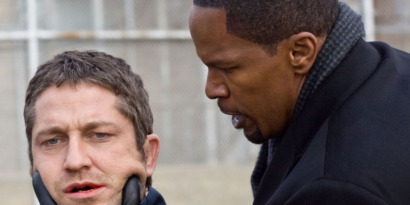 Jamie Foxx&rsquo;s Nick tightly gripping the jaw of Gerard Butler&rsquo;s Clyde in Law Abiding Citizen