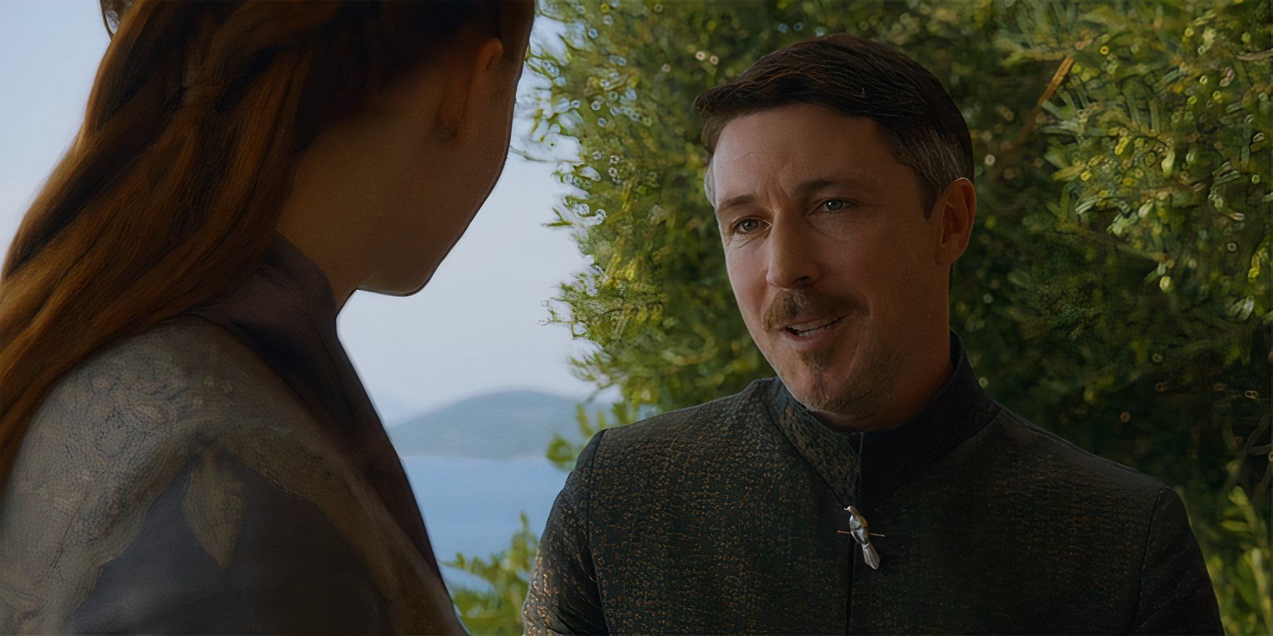 Littlefinger sitting with and  speaking to Sansa Stark in Season 3 Episode 5 of Game of Thrones.
