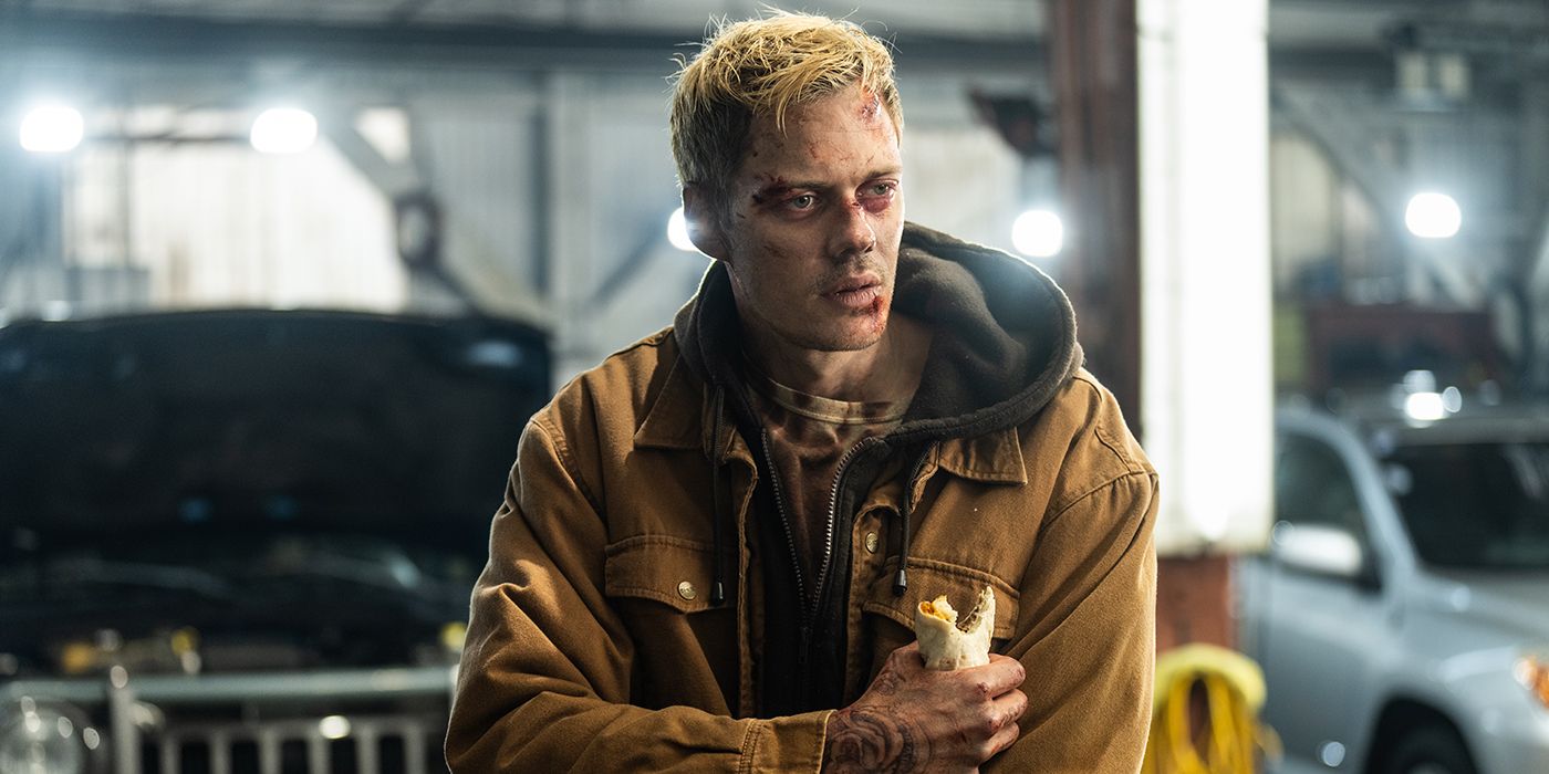 Bill Skarsgard in a jacket with a bruised and cut up face holding a burrito and looking exhausted in Locked