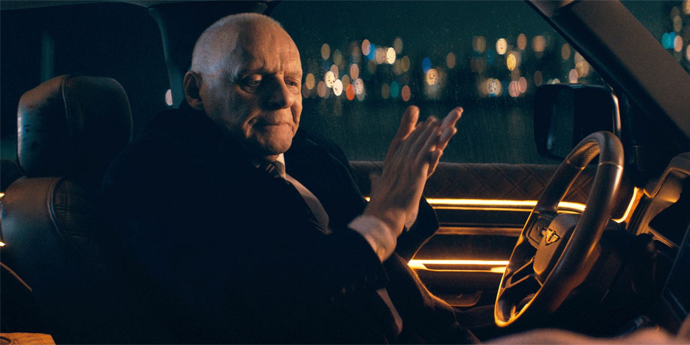 Anthony Hopkins rubbing his hands together in the driver&rsquo;s seat of a car at night in Locked