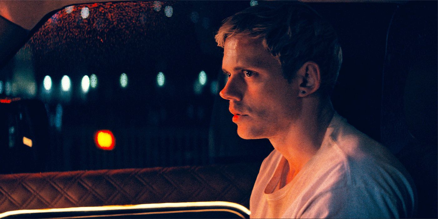 Bill Skarsgard in a white T-shirt looking frightened in a passenger seat at night in Locked