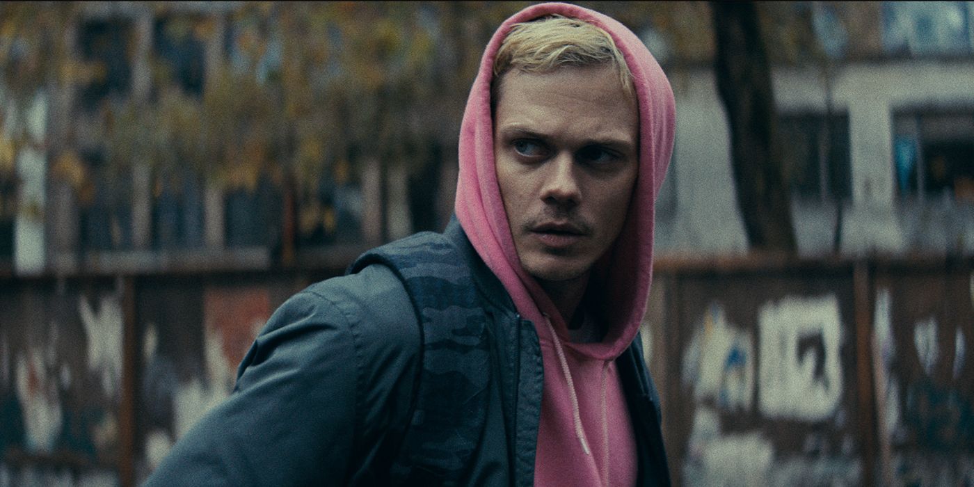 Bill Skarsgard in a pink goodie and jacket with blonde hair as Eddie in Locked