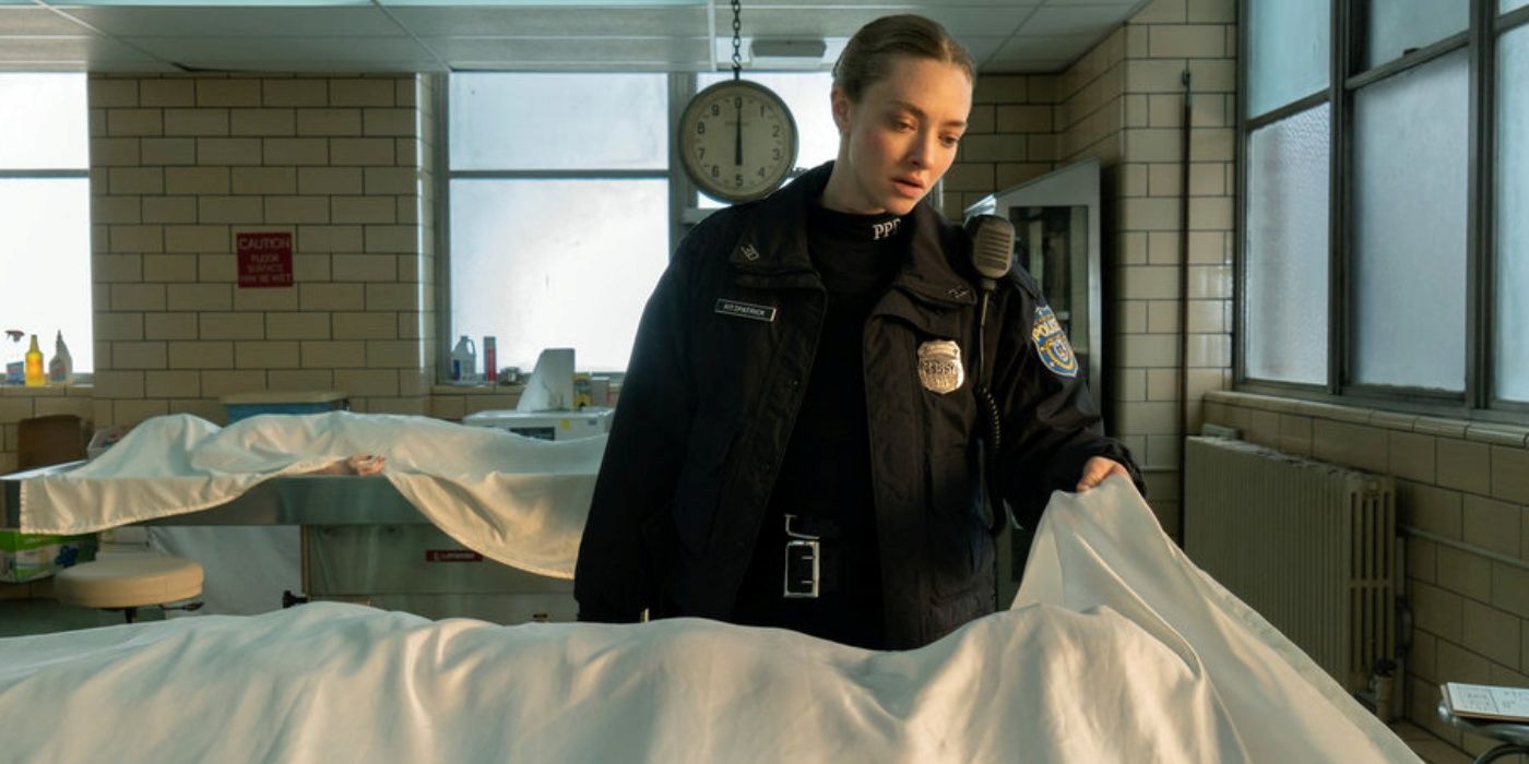 Amanda Seyfried as Mickey lifting up a sheet over a body in the morgue in Long Bright River