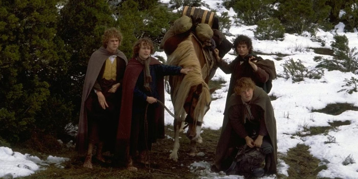 Merry, Pippin, Frodo, and Sam surround Bill the Pony in a snowy landscape in The Lord of the Rings