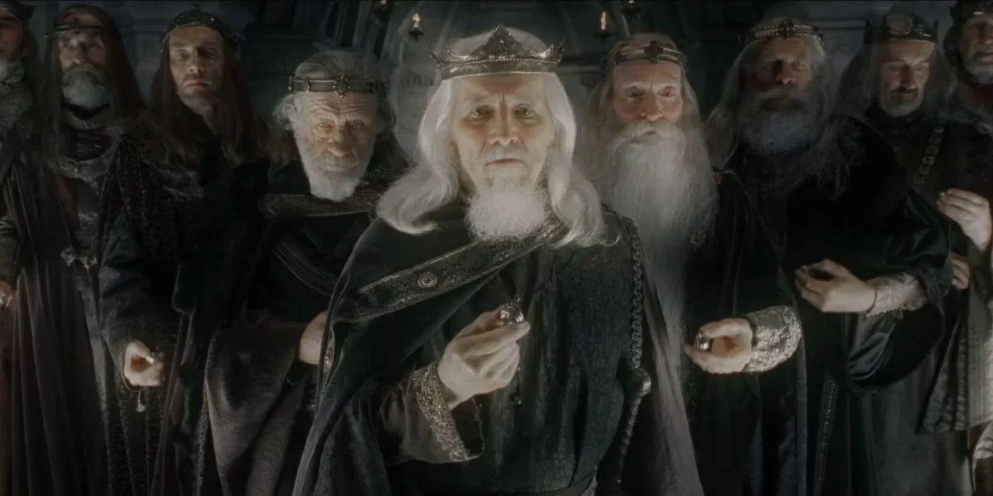 Nine men wearing crowns hold rings and stare at the camera