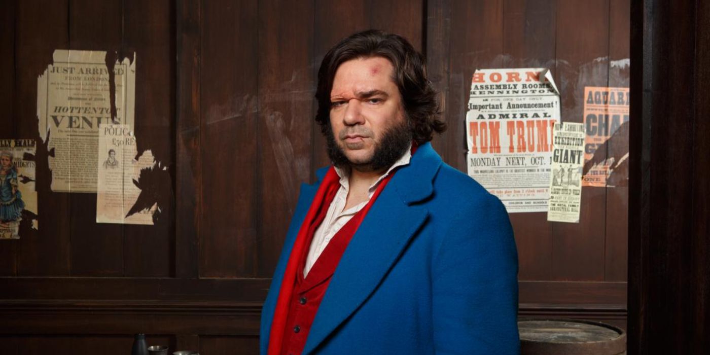 Matt Berry as detective Eli Rabbit, posing in a blue jacket and red shirt in the show Year of the Rabbit.