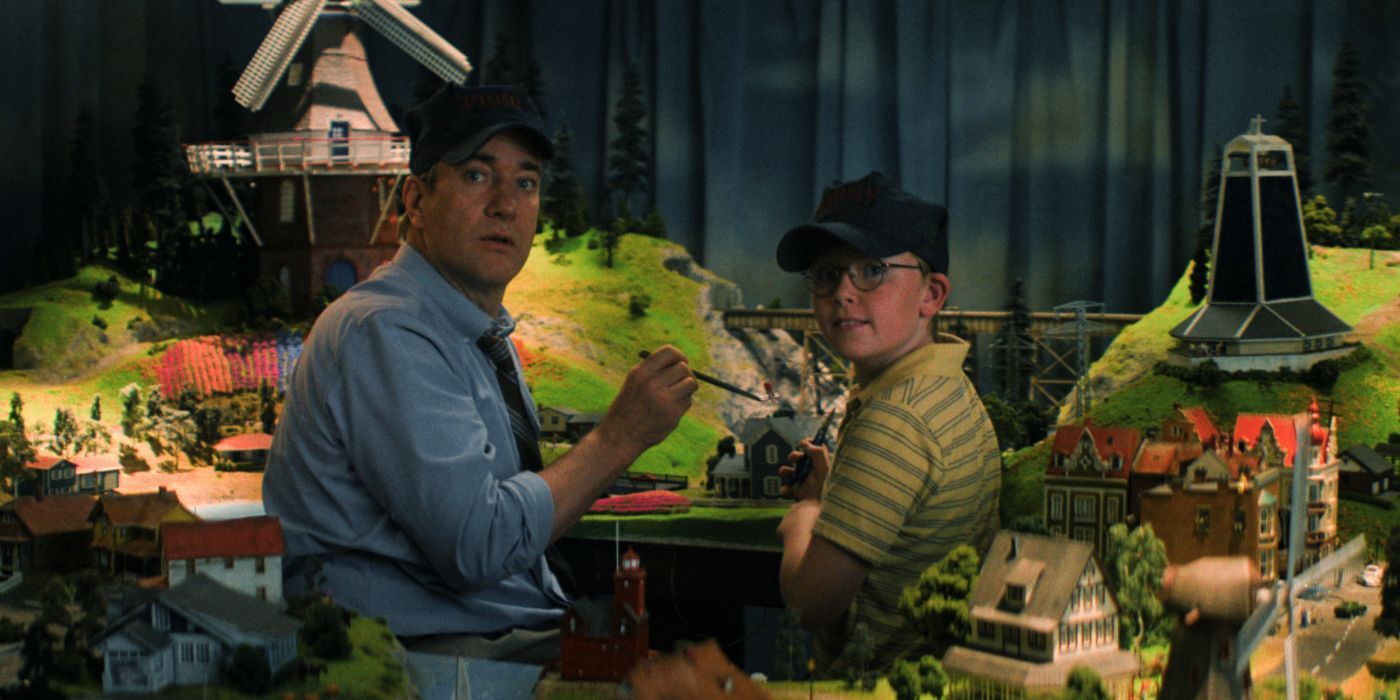 Matthew Macfadyen and Jude Hill working on a model train set.