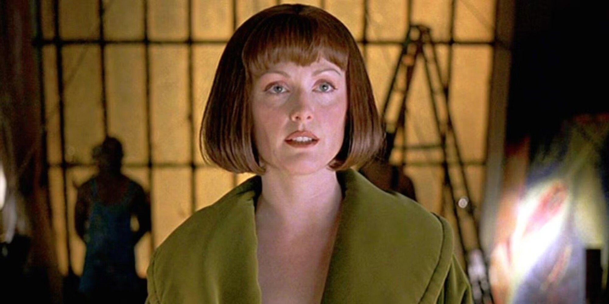 Julianne Moore as Maude Lebowski standing in front of art looking past the camera in The Big Lebowski, 1998.