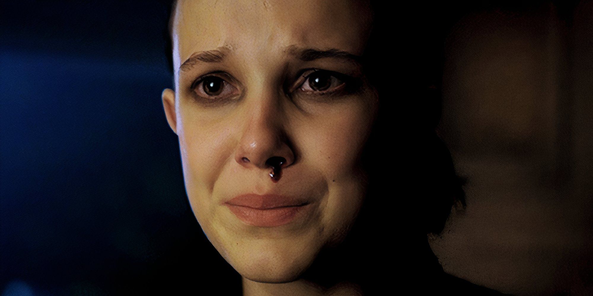 Millie Bobby Brown as Eleven in Stranger Things with a bloody nose and looking emotional.
