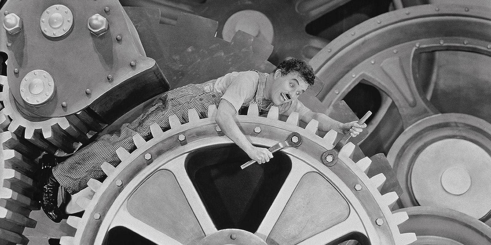 Charlie Chaplin tumbling through the factory gears in &lsquo;Modern Times&rsquo;