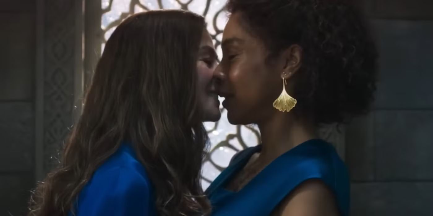 Young Siuan (Sophie Okonedo) and Moiraine (Rosamund Pike) kissing in The Wheel of Time