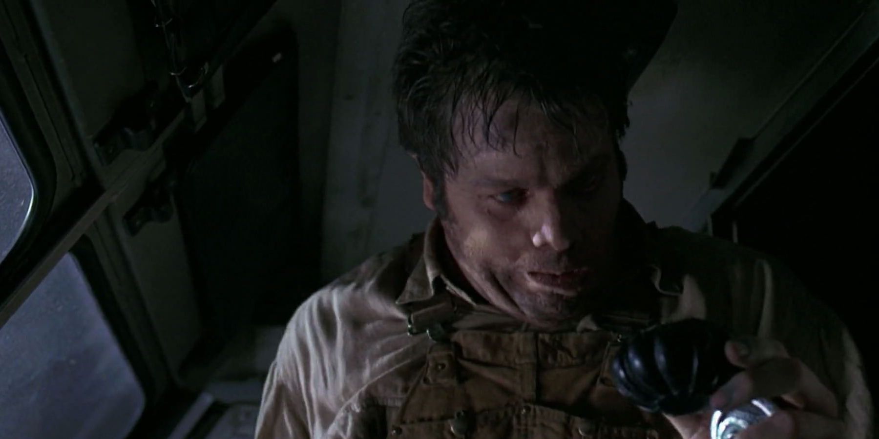 Vincent D&rsquo;Onofrio as Edgar looking at a small object in &lsquo;Men In Black&rsquo;.