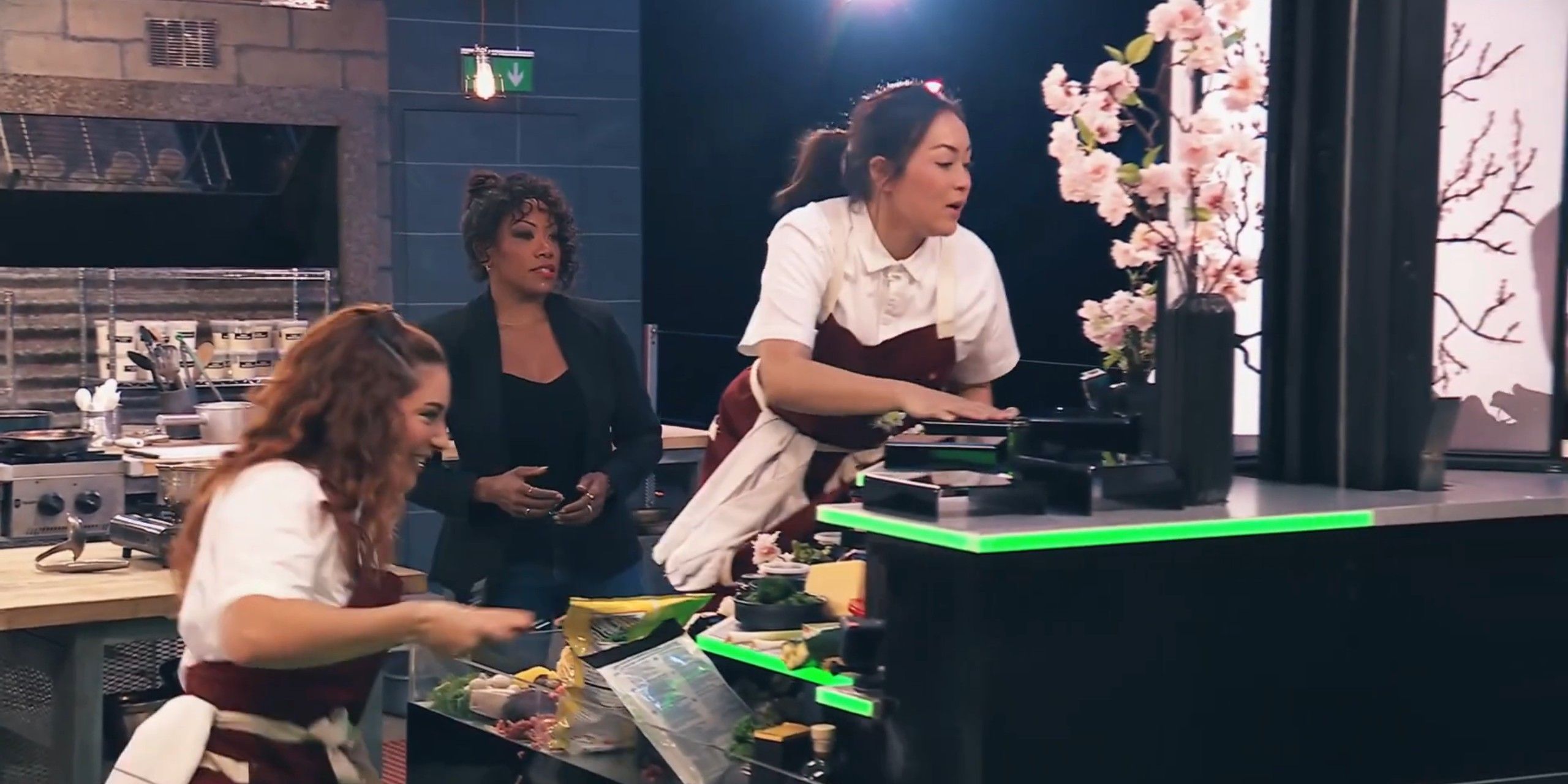 Next Level Chef - two contestants hurriedly cooking.