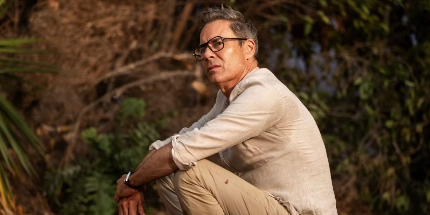 Eric McCormack sitting in a forest in Nine Bodies in a Mexican Morgue