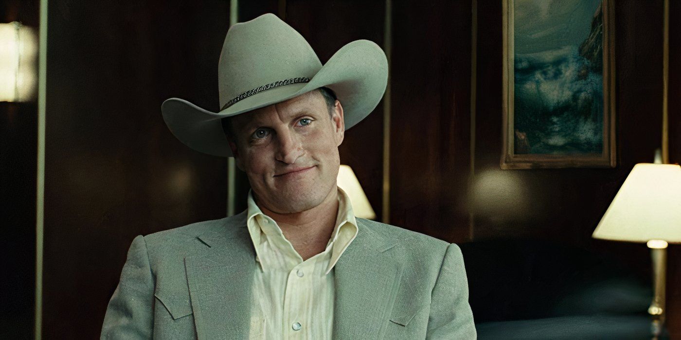 Woody Harrelson as Carson Wells sitting in an office and wearing a cowboy hat in No Country for Old Men.