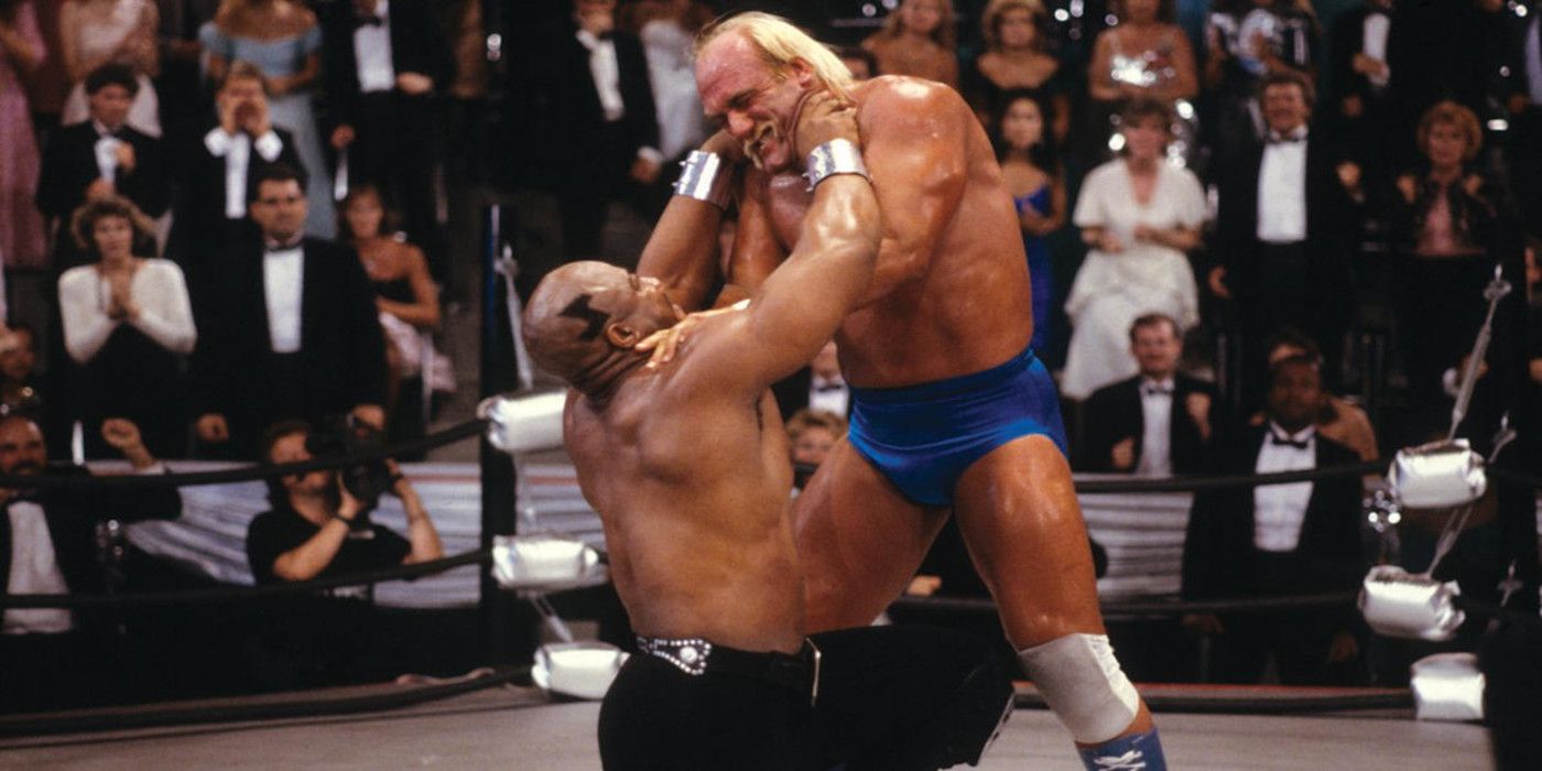 Hulk Hogan as Rip wrestles Tiny Lister as Zeus in a wrestling arena with a crowd watching in No Holds Barred.