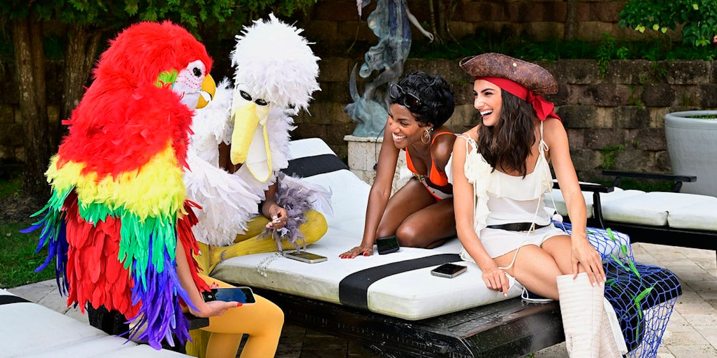 Paige DeSorbo and Gabby Prescod in pirate attire laughing at two people in bird costumes 'Summer House'