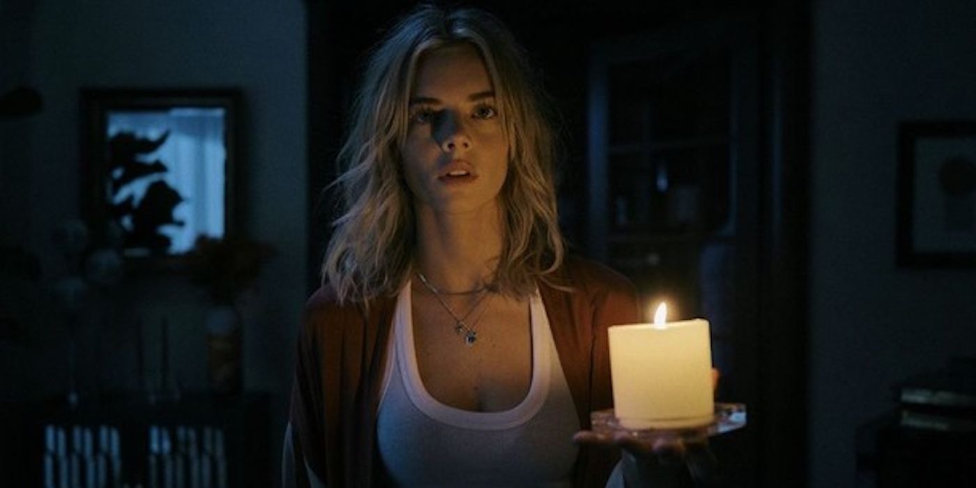 Samara Weaving as Sofia holding a candle in Borderline