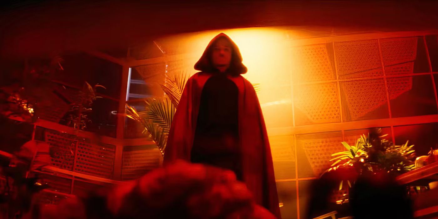 The Hood is shrouded in red and yellow light in a still from Ironheart
