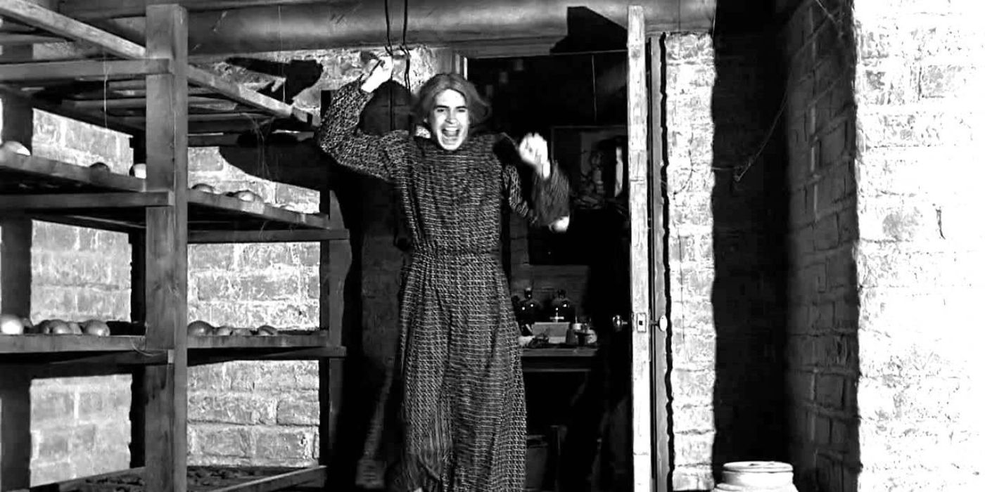 Norman Bates dressed as his mother wielding a knife in Psycho.