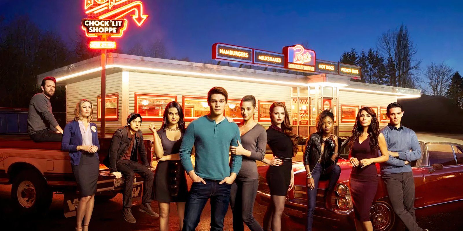 Riverdale cast standing in front of the diner.