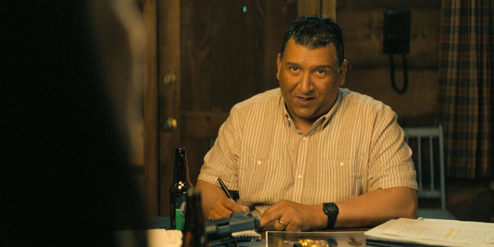 Guillermo Villanueva sitting down and talking to someone off-camera in Reacher