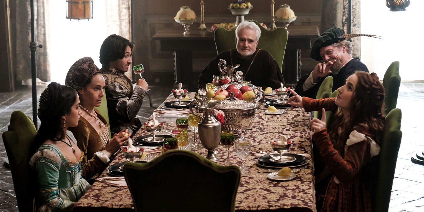The cast of Rosaline all sitting around a table
