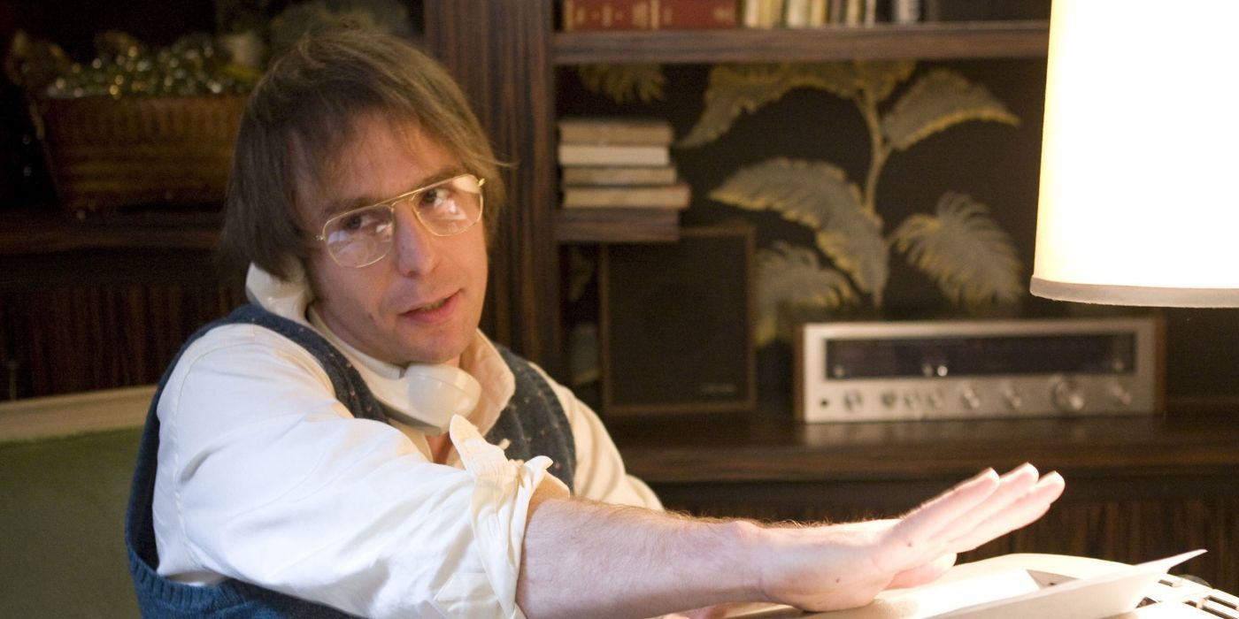 Sam Rockwell as James Reston Jr. on a landline phone, sitting at a desk in Frost/Nixon.