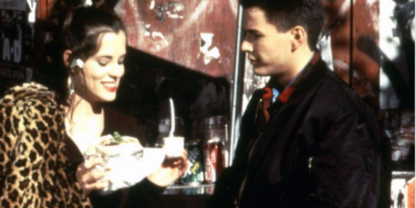 Parker Posey and Omar Townsend as Mary and Mustafa wearing a leopard printed fur coat holding a falafel in &lsquo;Party Girl&rsquo;