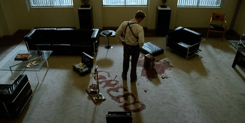 Detective Mills (Brad Pitt) looks at the "greed" crime scene in the thriller Se7en.