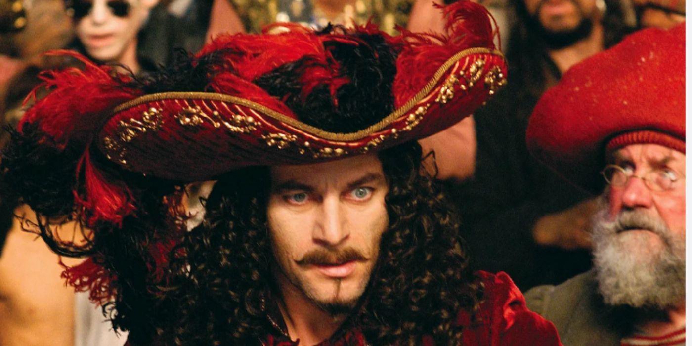 Jason Isaacs as Captain Hook wearing a red hat and red coat in &lsquo;Peter Pan&rsquo;.