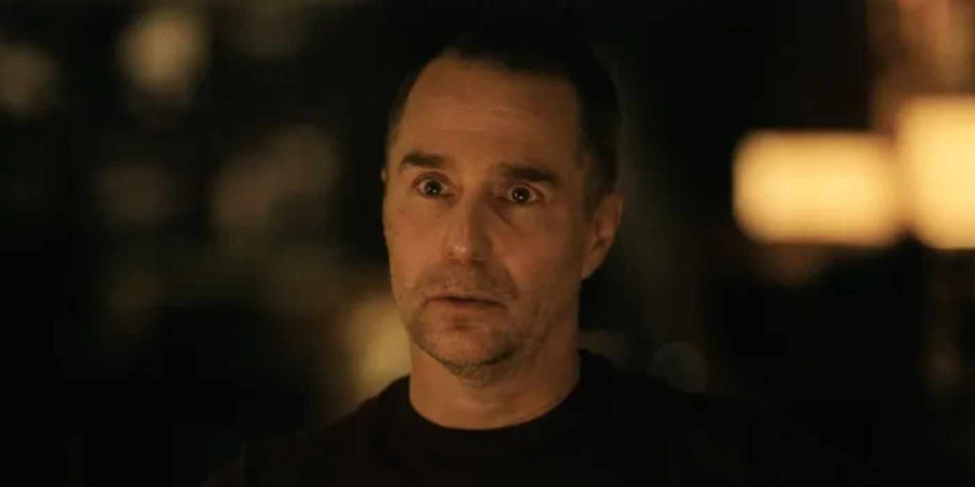 Sam Rockwell as Frank staring forward in a brown shirt in &lsquo;The White Lotus&rsquo;.