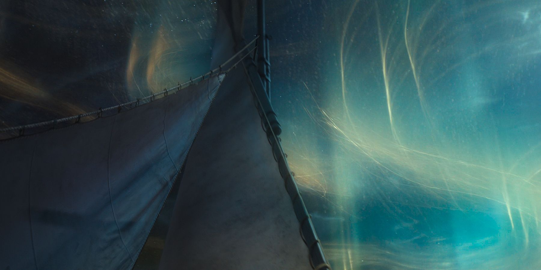 The mast of a Sea Folk ship with the One Power in the sky behind it from The Wheel of Time Season 3 Episode 5