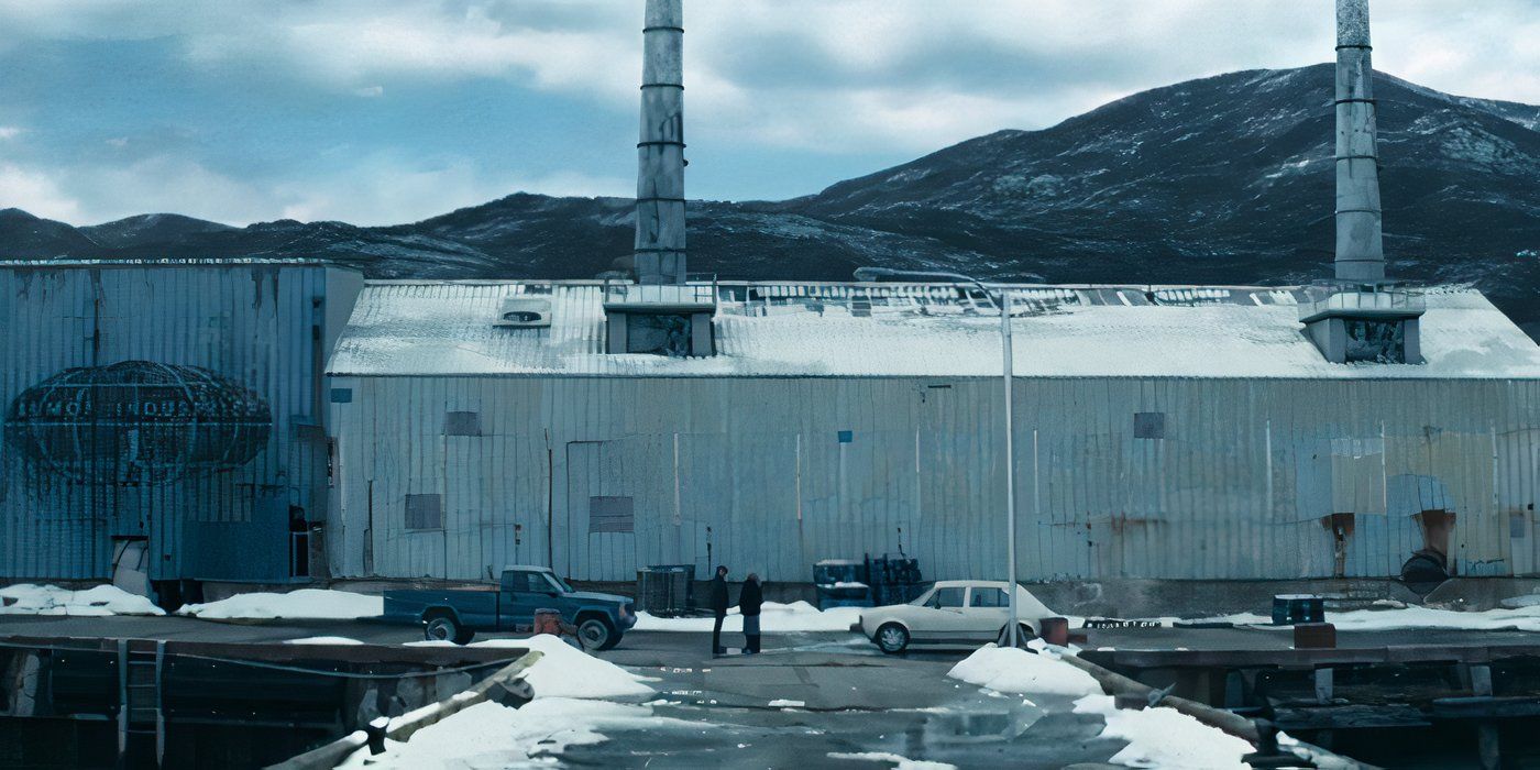 A wide shot of Hampton (James Le Gros) and Harmony Cobel (Patricia Arquette) standing in front of a Lumon Industries ether mill in Severance on Apple TV+.