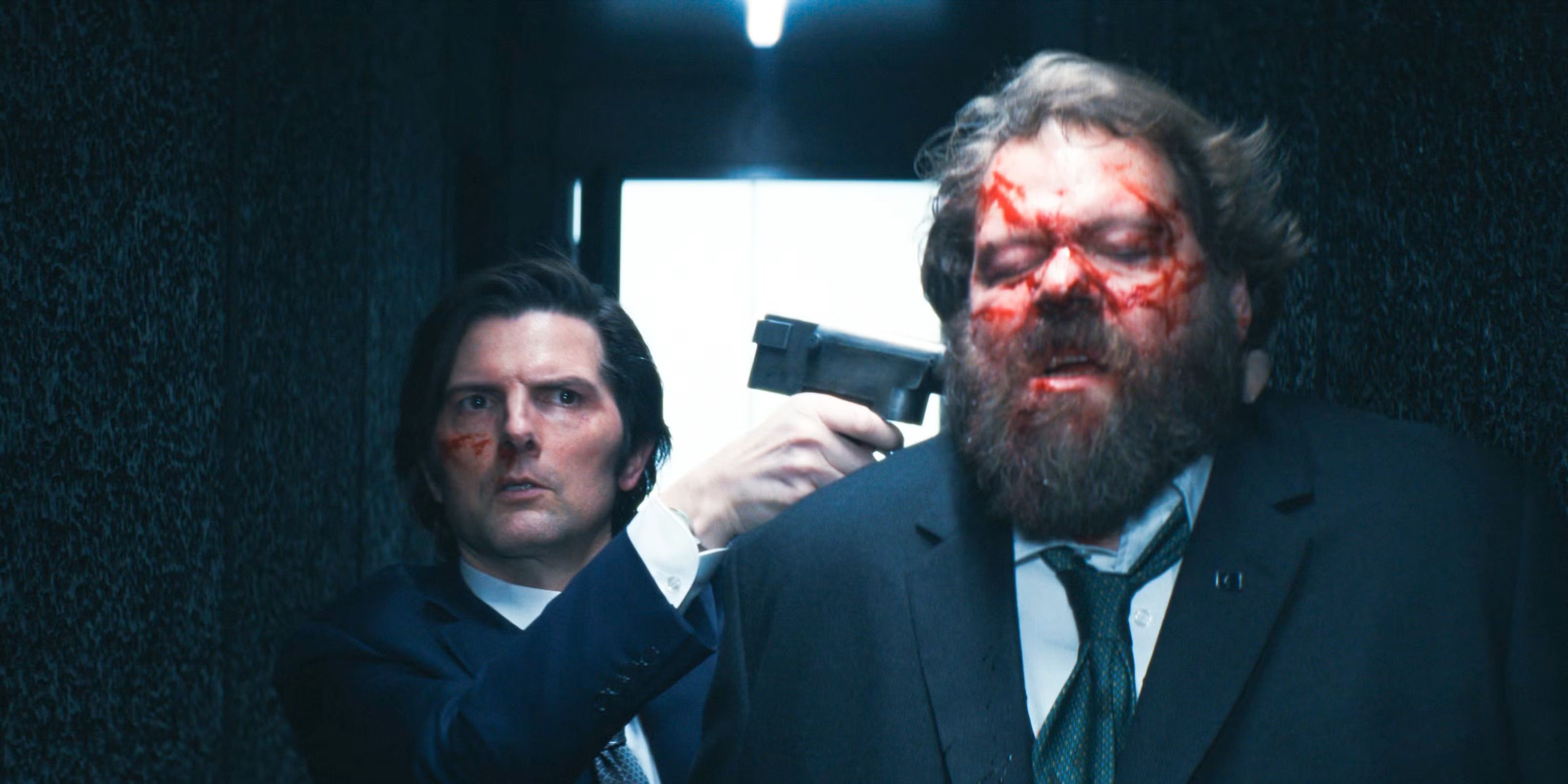 Adam Scott as Mark, holding a gun to Drummond&rsquo;s (Ólafur Darri Ólafsson) neck, with blood on both their faces in Severance
