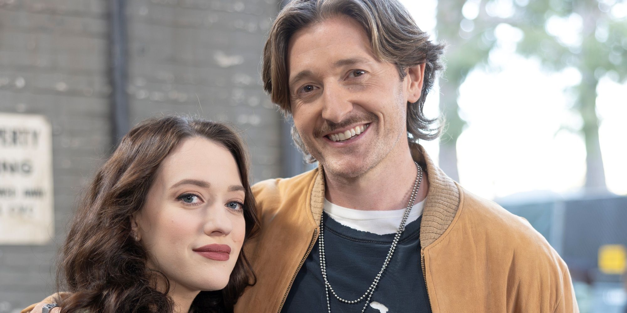 Lucas Neff as Jimmy with his arm around Kat Dennings as Riley in Shifting Gears
