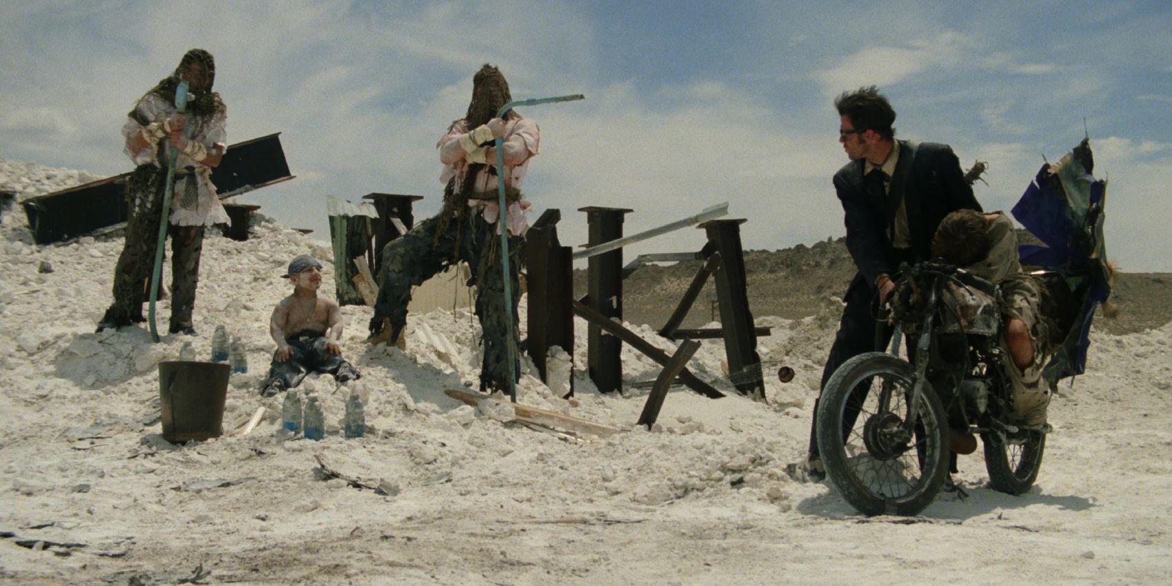 Two men aiming guns to another man in Six-String Samurai