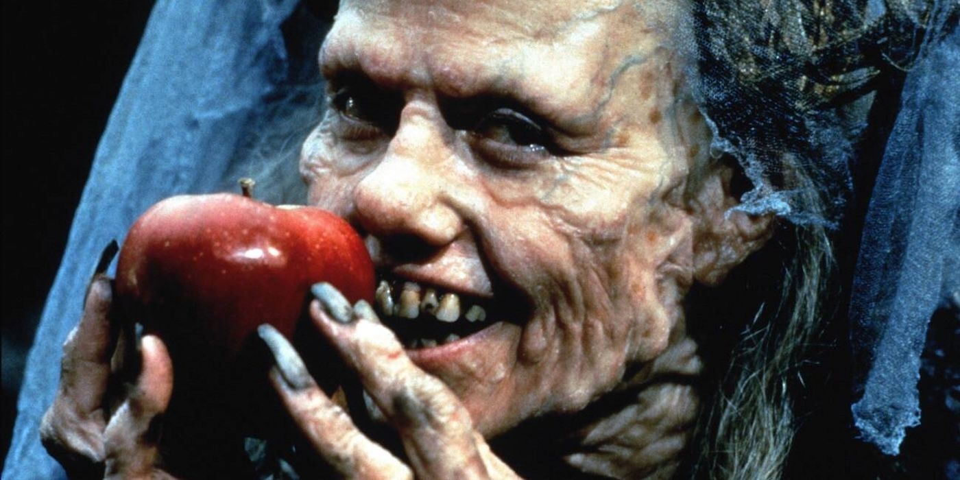 Sigourney Weaver as Claudia Hoffman holding an apple in Snow White: A Tale of Terror