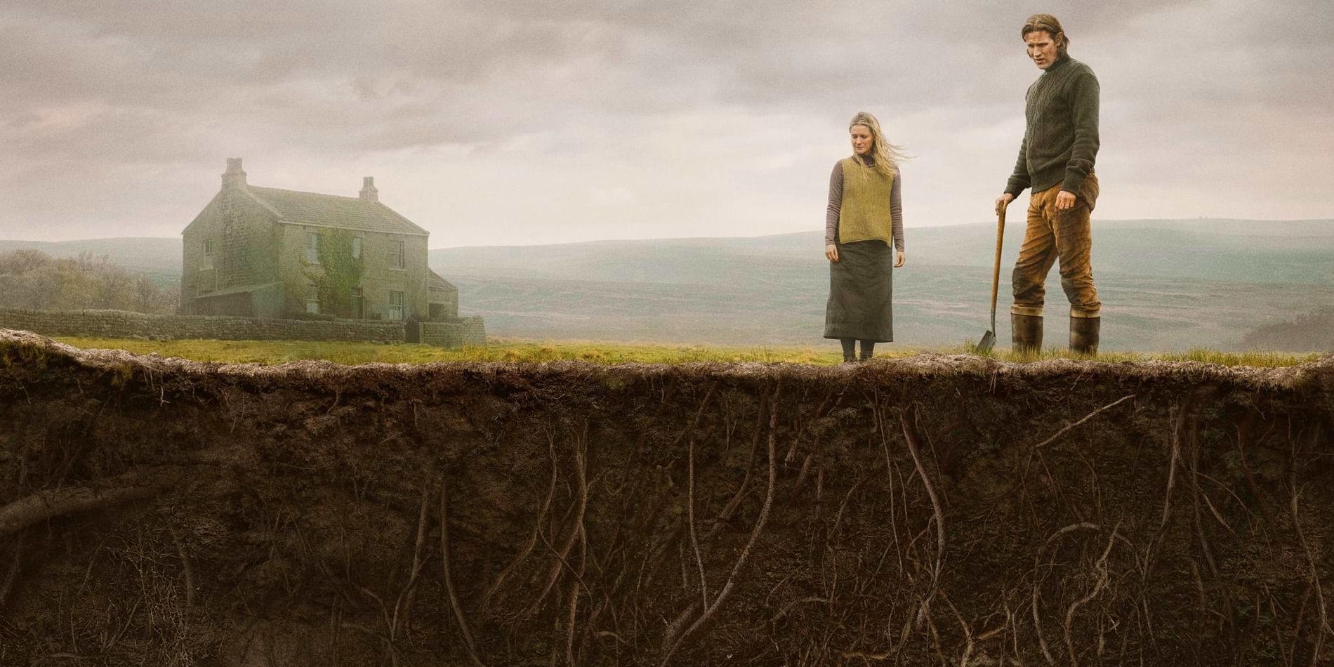 Richard and Juliette, played by actors Matt Smith and Morfydd Clark, stand outside a farmhouse looking down at the ground, while the lower layers of earth show deep roots in Starve Acre.