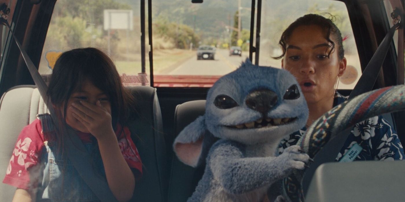 Stitch (Chris Sanders) takes the steering wheel, surprising Nani (Sydney Elizebeth Agudong) while Lilo (Maia Kealoha) laughs in Lilo and Stitch (2025).