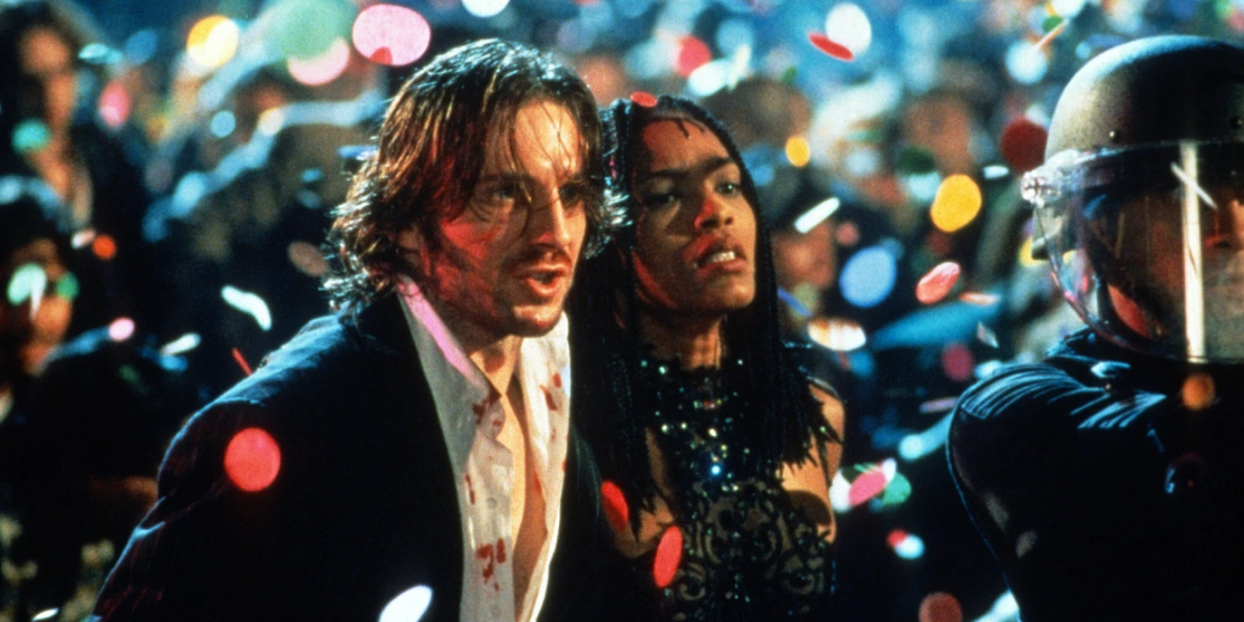 Ralph Fiennes and Angela Bassett in a crowd with confetti in Strange Days.