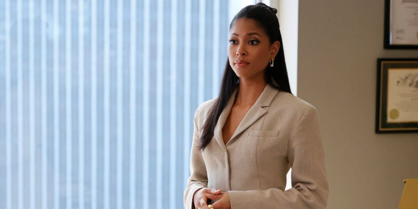 Lex Scott Davis as Erica standing in her office in a tan suit in the NBC series Suits: LA