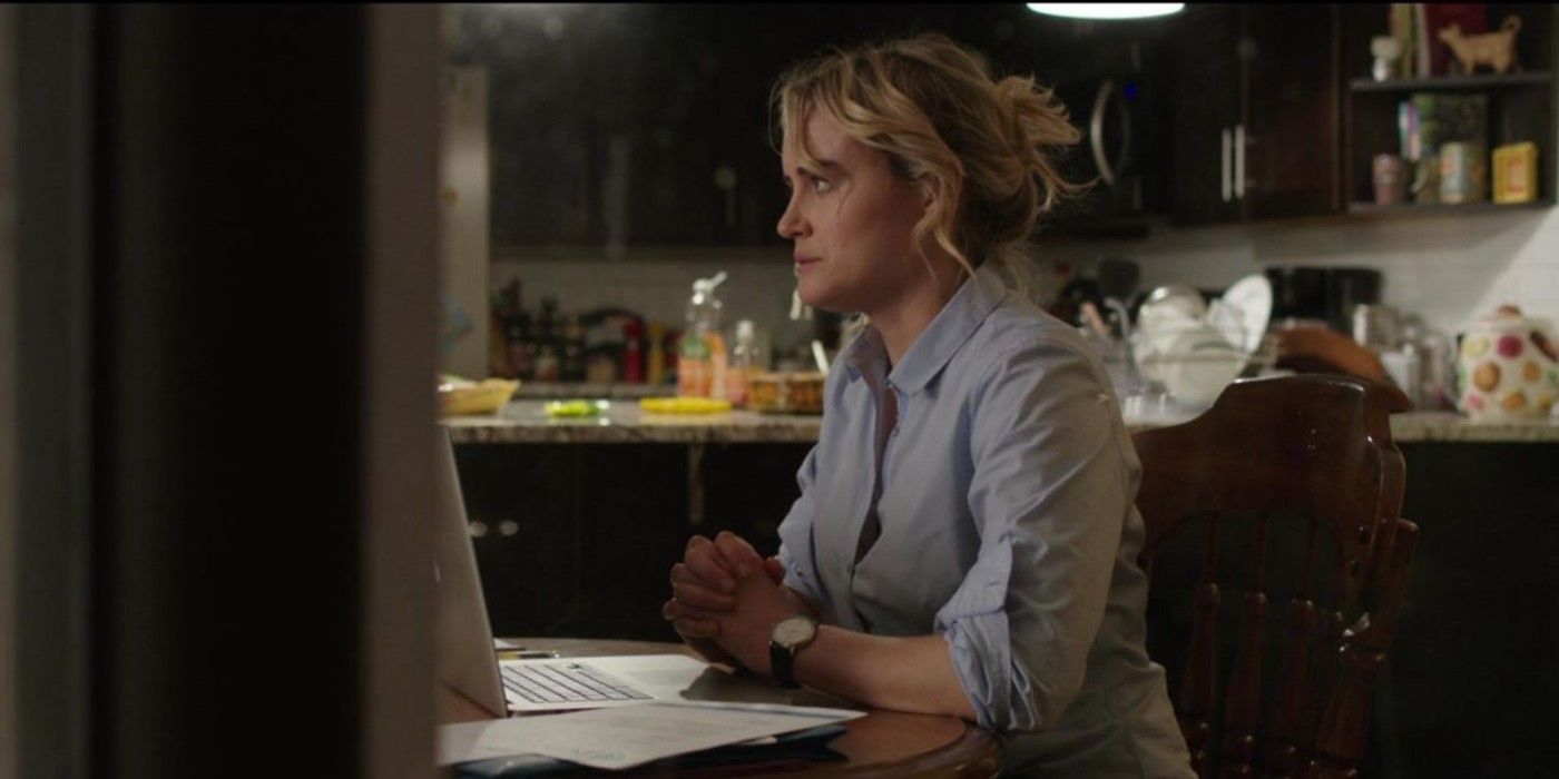 ​​​​​​​ Taylor Schilling (Kate) seated at her desk in front of her laptop in Family