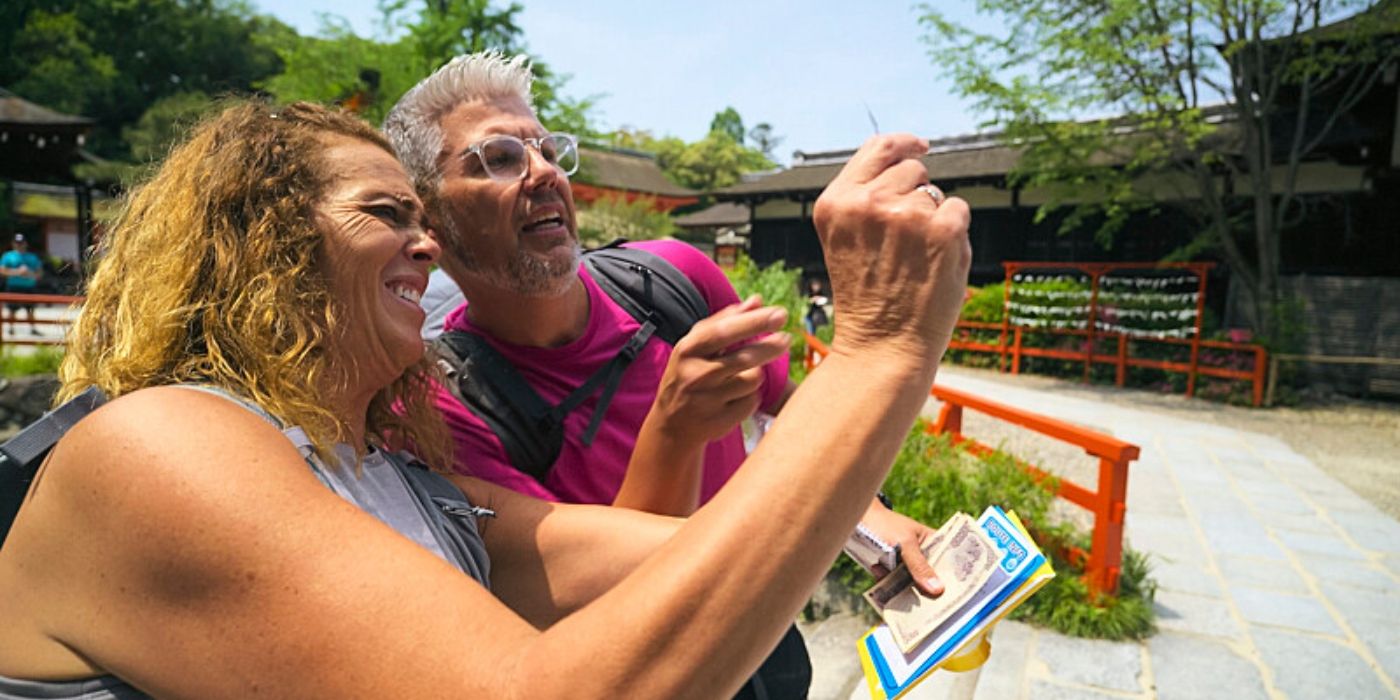 Scott and Lori hold up the magic paper in Kyoto on &lsquo;The Amazing Race&rsquo; Season 37.