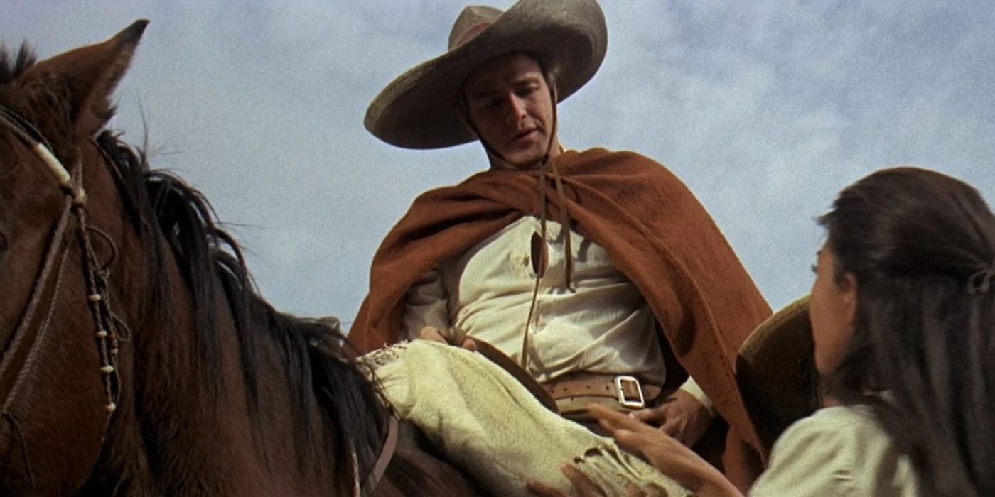 Marlon Brando on a horse looking down at someone in The Appaloosa